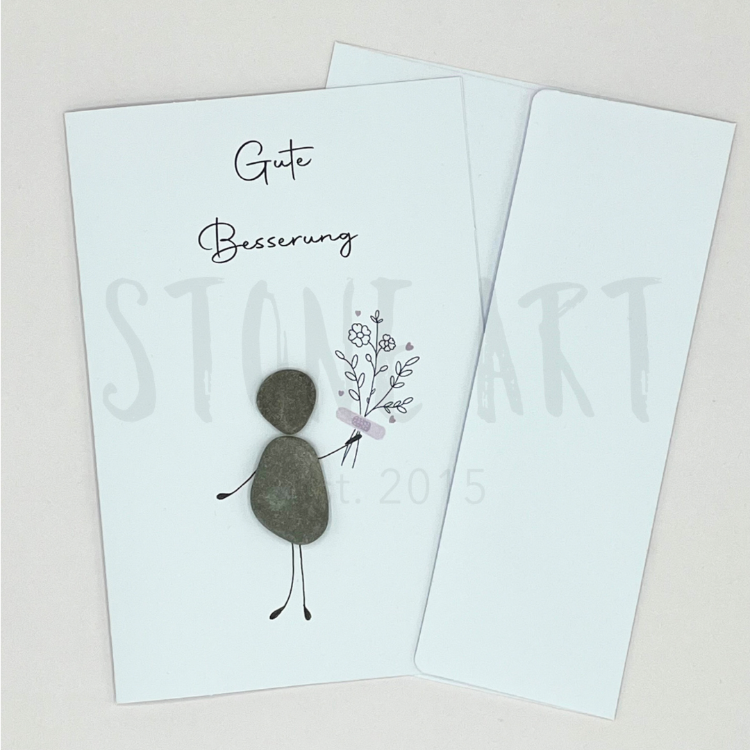 Handgemachte weiße Klappkarte mit Kieselstein, mit Spruch „Gute Besserung" und Mensch mit Blumenstrauß