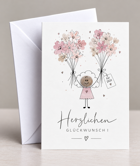 Handgemachte weiße Klappkarte mit Kieselstein, mit Spruch „Herzlichen Glückwunsch" und Mädchen mit Blumen