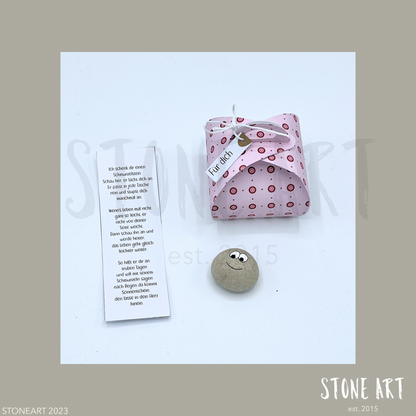 Handgefertigter Schmunzelstein von Stoneart2015 in Form eines kleinen Steins mit einem fröhlichen Gesicht. Der Stein dient als Glücksbringer, Trostspender und Mutmacher – ideal als kleines Geschenk oder Mitbringsel.