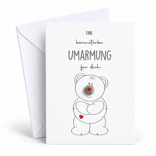 Handgemachte weiße Klappkarte mit Kieselstein-Nase und Bär mit Herz, Spruch „Eine bärenstarke Umarmung für dich“ – Karte zum Trösten und Aufmuntern, Grußkarte mit Umschlag