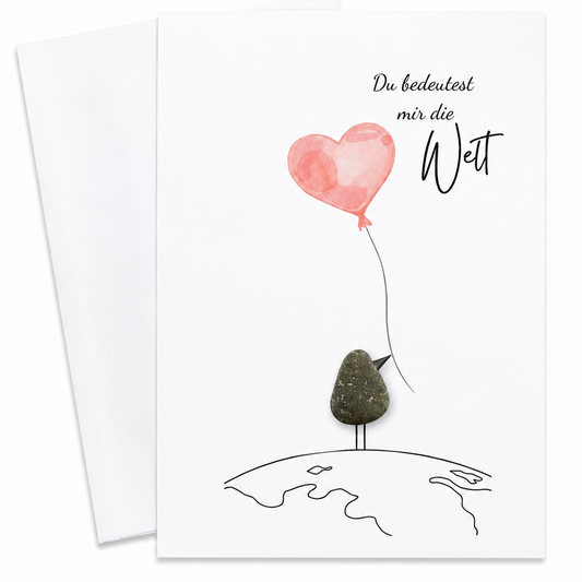 Handgemachte weiße Klappkarte mit Kieselstein-Vogel mit rosa Herzballon auf der Weltkugel, Spruch „Du bedeutest mir die Welt“ – Liebeskarte zum Valentinstag und Jahrestag, Grußkarte mit Umschlag